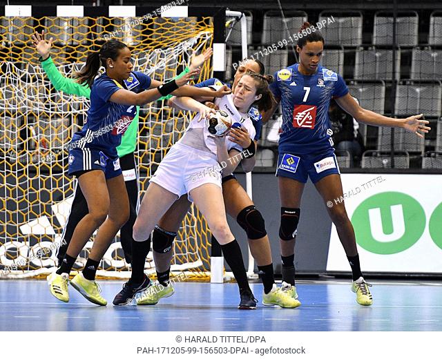 Paraguay's Sabrina Conce Fiore Canata Morinigo (C) is blocked by France's Estelle Nze Minko (L-R), Beatrice Edwige and Allisson Pineau during the World Women's...