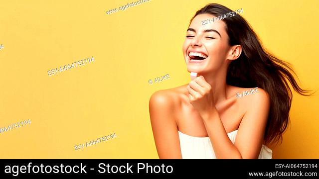 Portrait of beautiful young woman with clean fresh skin on yellow background