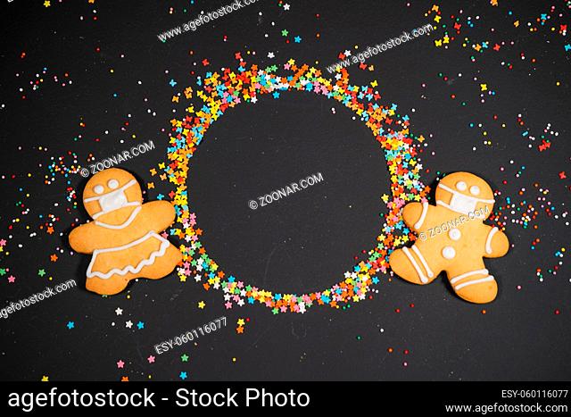 Christmas background with gingerbread on gray surface. Holiday mood card. Top view, copy space