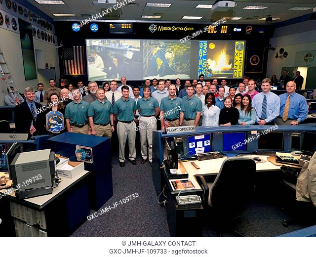 The members of the STS-126 ascent flight control team and the flight's crewmembers pose for a group portrait in the space shuttle flight control room in the...