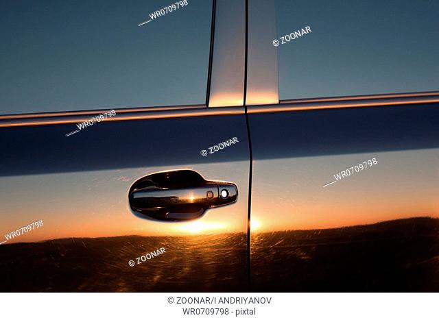 Car sunset reflection