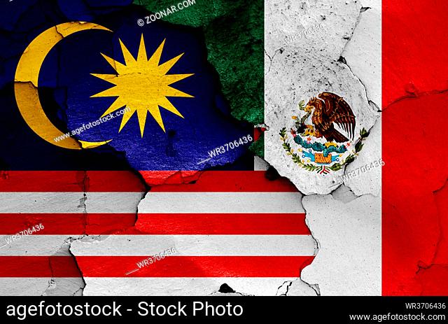 flags of Malaysia and Mexico painted on cracked wall