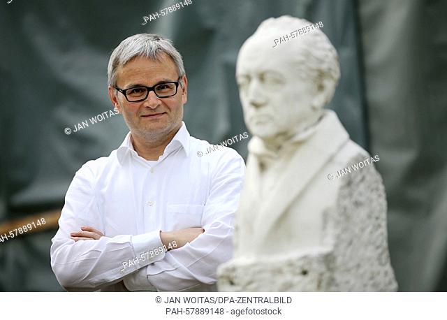 Rene Schmidt, director of the historical cure facilities and of the Goethe theatre poses behind a bust of Goethe at the theatre in Bad Lauchstaedt, Germany