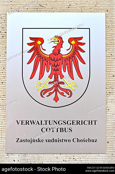23 November 2023, Brandenburg, Cottbus: The red eagle, the coat of arms of the state of Brandenburg, adorns a sign from the Cottbus Administrative Court