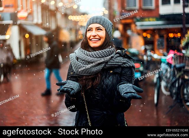 girl in the street in the rain posing on the camera