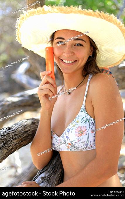Young woman and sunscreen
