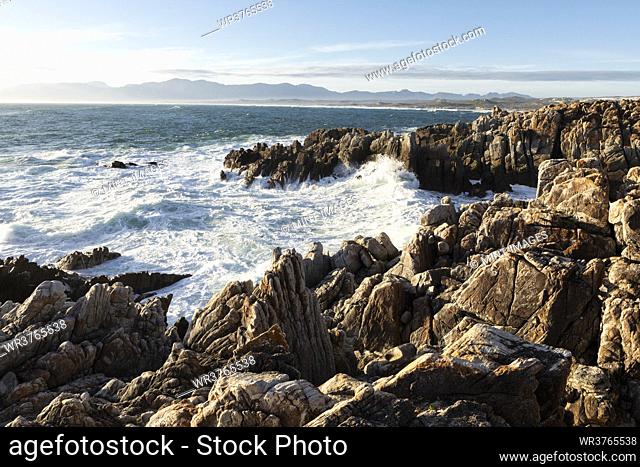Jagged rocks on the Atlantic ocean coastline and white water waves breaking