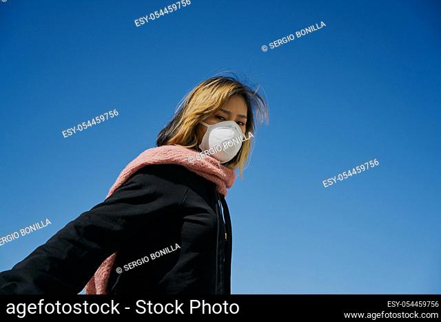 Asian woman with a protective mask. The concept of Coronavirus