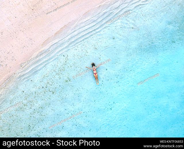 Woman relaxing and swimming in sea at beach