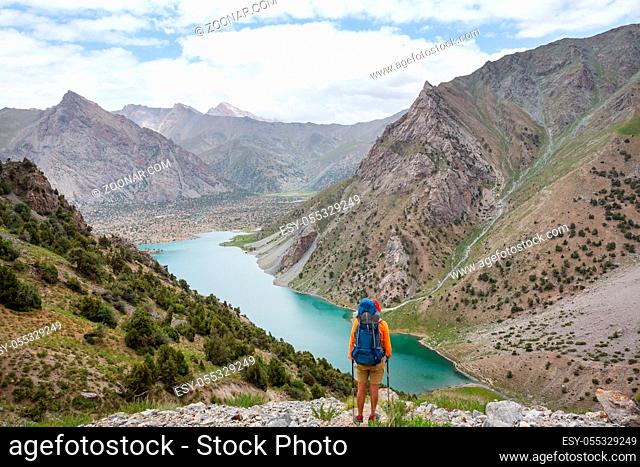 Wanderlust time. Man hiking in beautiful Fann mountains in Pamir, Tajikistan. Central Asia