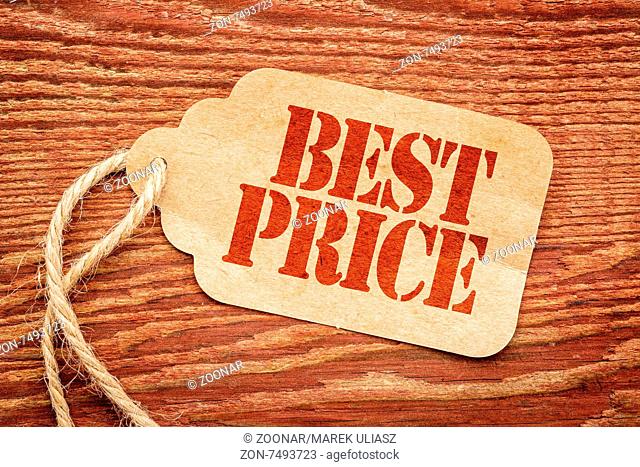 best price sign a paper price tag against rustic red painted barn wood - marketing concept