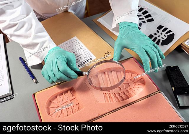 Forensic scientist investigates shoeprint mould evidence in crime lab, conceptual image