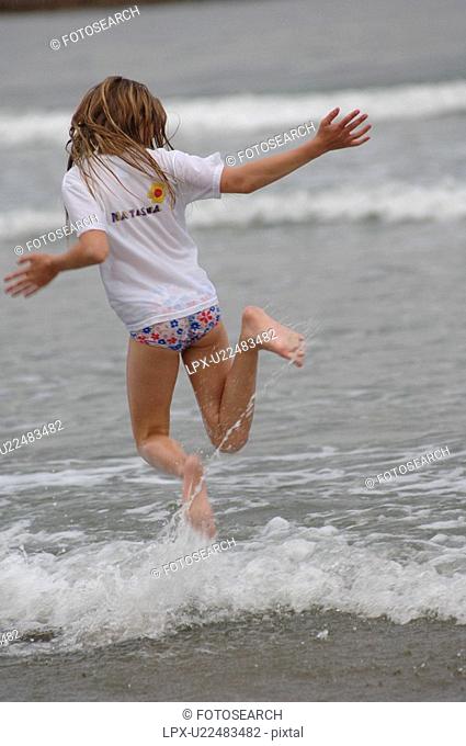 Girl running through water