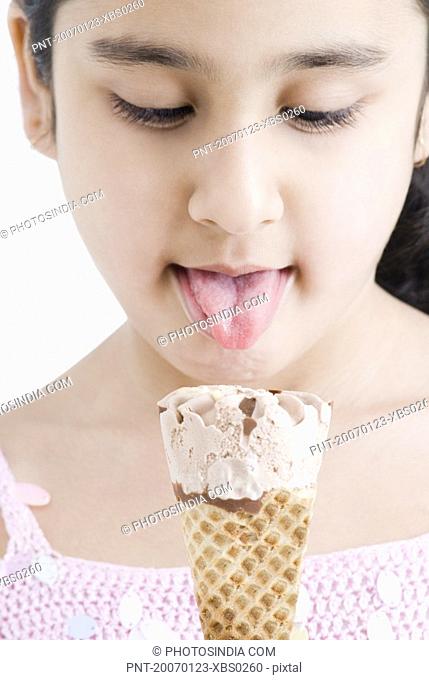 Close-up of a girl licking an ice cream cone