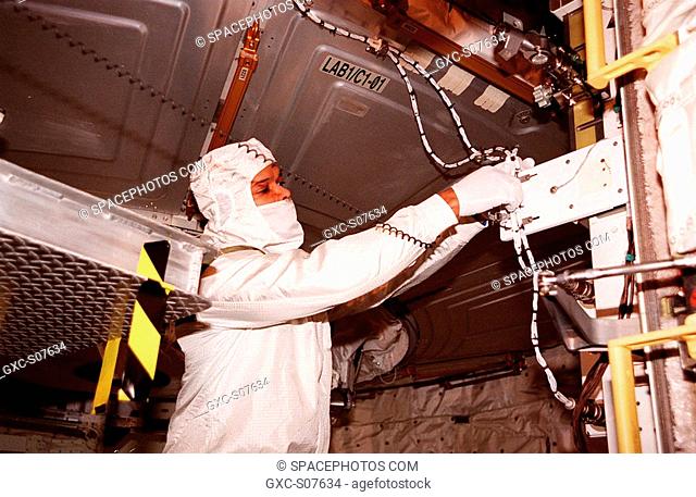 01/06/2001 -- In the payload bay of the orbiter Atlantis, STS-98 Mission Specialist Robert Curbeam works with equipment he will use in space to attach the U