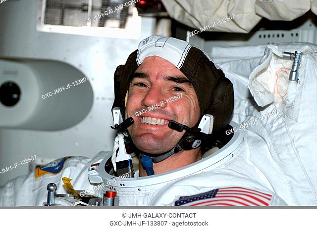 Astronaut Rex J. Walheim, STS-110 mission specialist, attired in his Extravehicular Mobility Unit (EMU) space suit, is photographed in the Quest Airlock on the...