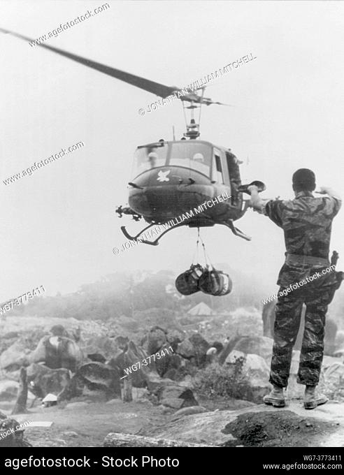 VIETNAM Shau Valley -- Mar / Apr 1969 -- A UH-1 ""Huey"" drops off supplies to waiting US soldiers near the Laotian border in the direction of the Shau Valley...
