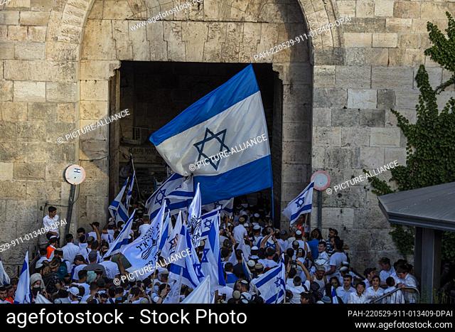 29 May 2022, Israel, Jerusalem: Israelis march with their national flags through the Damascus Gate as they head to the Western Wall as part of the Flag March...