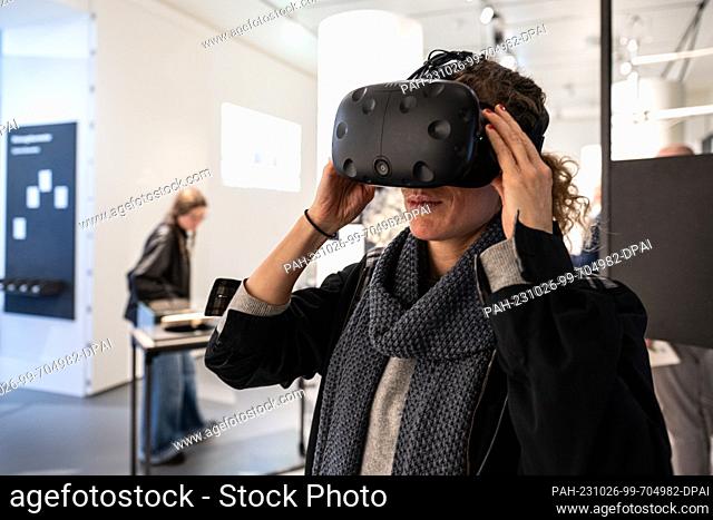 PRODUCTION - 25 October 2023, Lower Saxony, Göttingen: A visitor stands with 3D glasses in the special exhibition ""Digital Forest"" at Forum Wissen