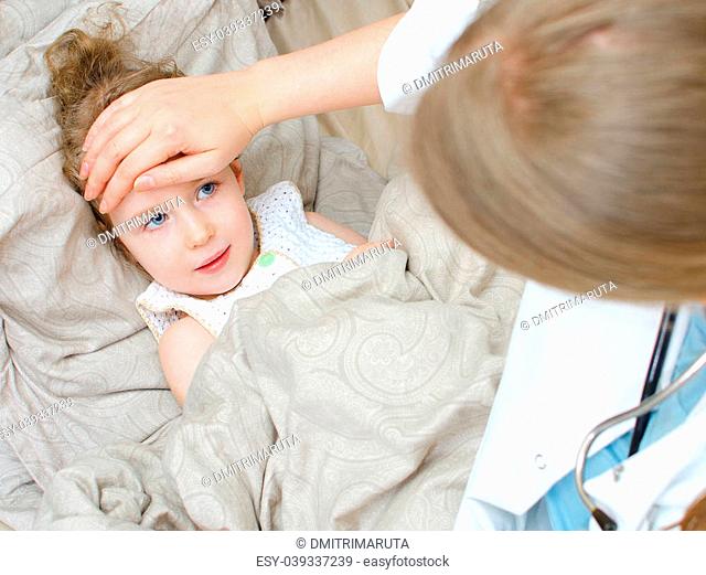 Top view of sick child lying in bed and visiting her doctor