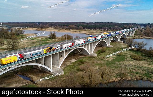 19 March 2020, Brandenburg, Frankfurt (Oder): Trucks are piling up on the bridge of highway 12 over the river Oder at the German-Polish border crossing (aerial...