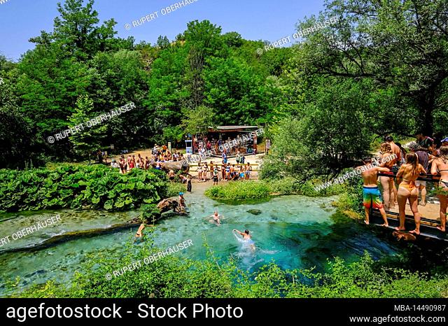 Muzina, Albania - Tourists bathe in Syri i Kaltër, THE BLUE EYE is the country's most abundant water source with 6 ö³/s, located midway between the larger...