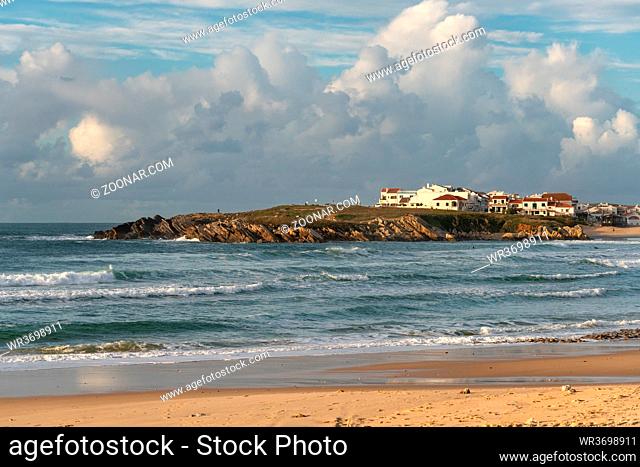 Baleal Island beach and beautiful houses with surfers on the atlantic ocean in Peniche, Portugal