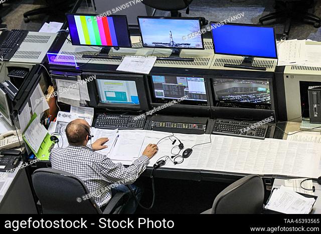 RUSSIA, MOSCOW REGION - DECEMBER 1, 2023: The centre's employee watches a live broadcast of the launch of a Soyuz-2.1a rocket booster carrying the Progress...