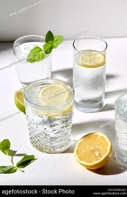 glasses with lemon water and peppermint on table
