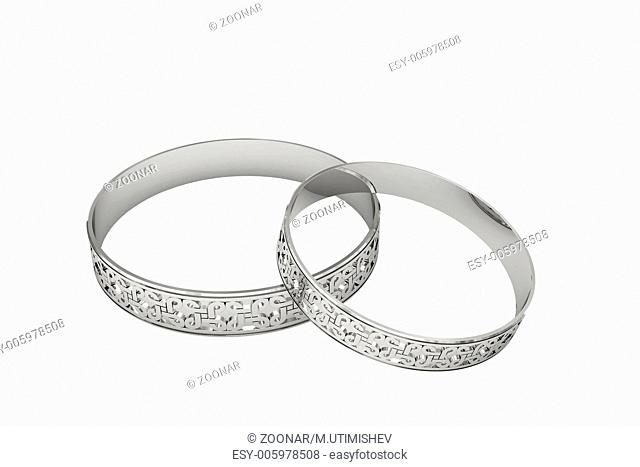 Silver or platinum wedding rings with magic tracery isolated on white. High resolution 3D image