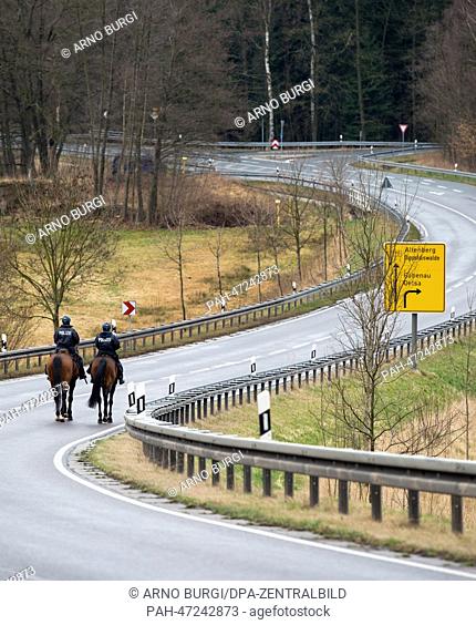 Mounted police officers secure Federal Highway 170 before the detonation of a WWII aerial bombs in a patch of forest between Karsdorf, Oberhaeslich and Rabenau