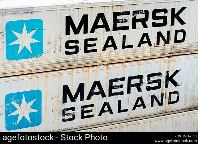 PETROPAVLOVSK CITY, KAMCHATKA, RUSSIAN FEDERATION - AUGUST 27, 2019: White shabby sea waves cargo containers Maersk company stacked on pier in container...