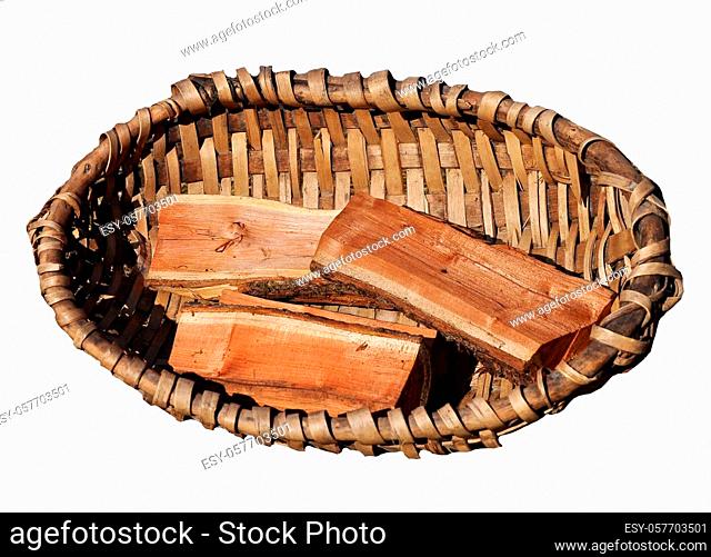 Old frame basket with firewood isolated on white