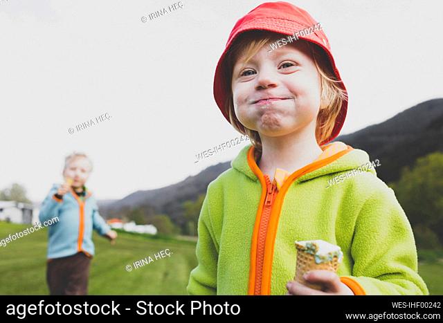 Portrait of little girl eating ice cream outdoors