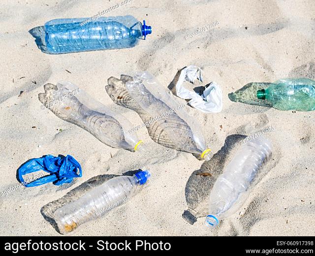 empty plastic water bottles plastic bag sand