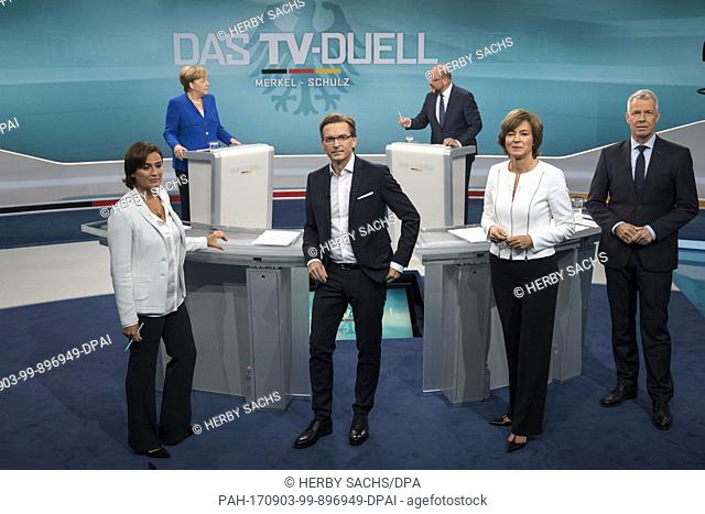 The candidates of the TVÂ duel Angela Merkel (back L)Â and Martin Schulz (back R) are having a conversation in the back, while hosts (front L-R)Â Sandra...