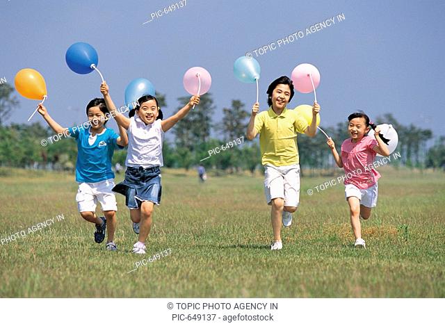 Korean Kids Playing in the Green Field