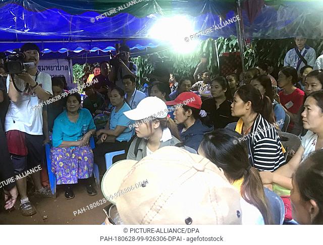 28 June 2018, Thailand, Chiang Rai, Mae Sai: ..Relatives of the youth football team who have been trapped in a cave for six days listen to an address by...