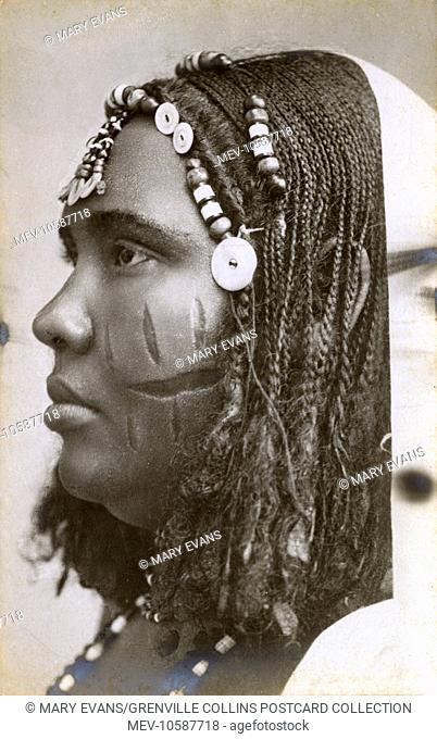 Fantastic photograph of a Sudanese woman with traditional decorative cuts on her face, braided hair (with buttons and beads) and a beaded necklace