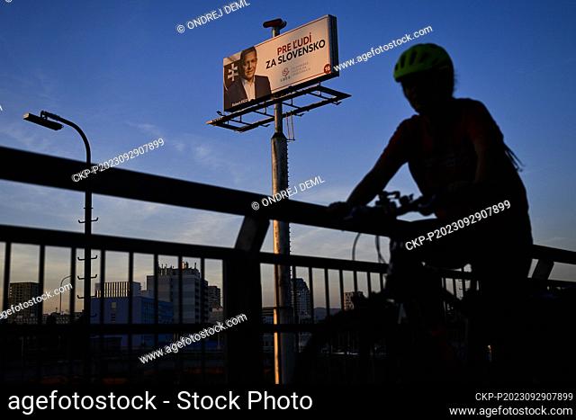 Cyclists rides past an election poster of Robert Fico, former prime minister and leader of the political party Smer-SD, Direction - Social Democracy