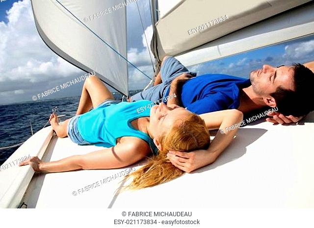 Young couple relaxing on sailboat deck