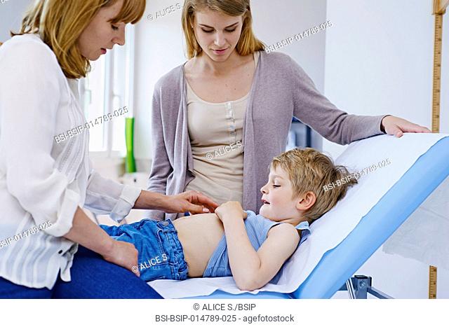 Doctor examining a child's abdomen