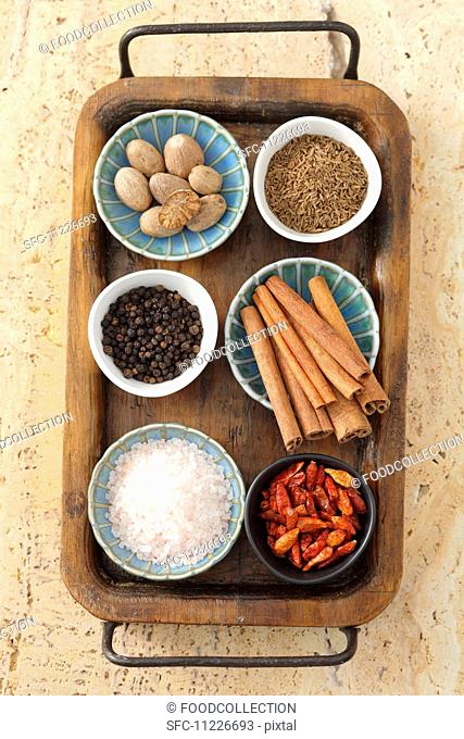 Assorted spices in bowls on a tray