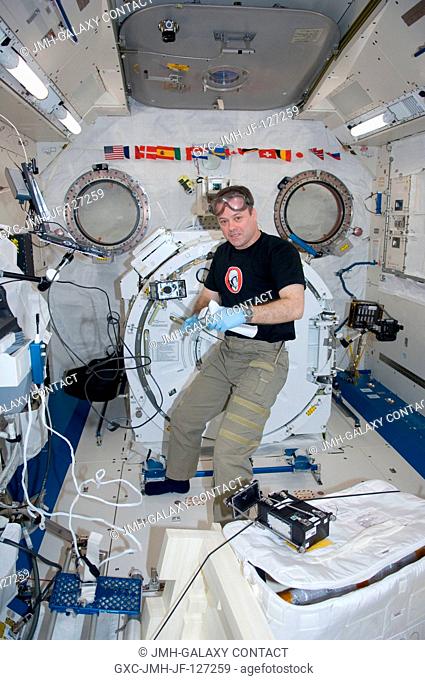 NASA astronaut Ron Garan, Expedition 27 flight engineer, supports the Dynamism of Auxin Efflux Facilitators responsible for Gravity-regulated Growth and...