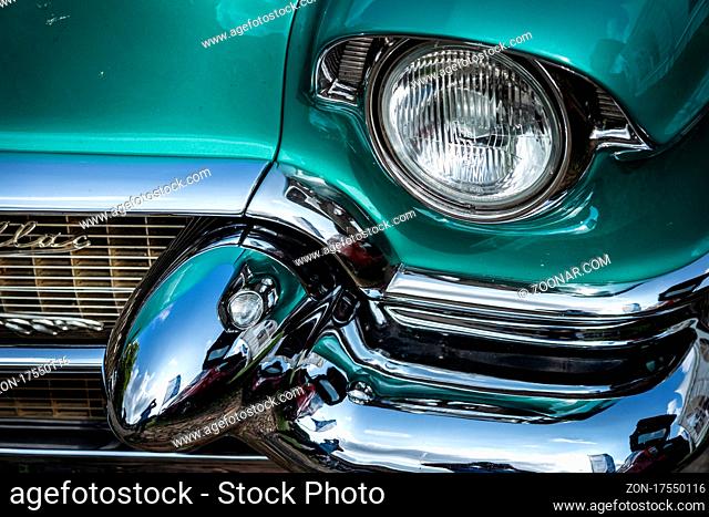 DIEDERSDORF, GERMANY - AUGUST 21, 2021: The headlight of luxury car Cadillac Series 62 Coupe de Ville, 1953. Close-up. The exhibition of