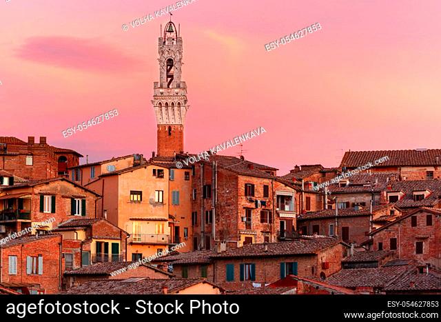 Mangia Tower or Torre del Mangia and Old Town of medieval city of Siena at gorgeous sunset, Tuscany, Italy