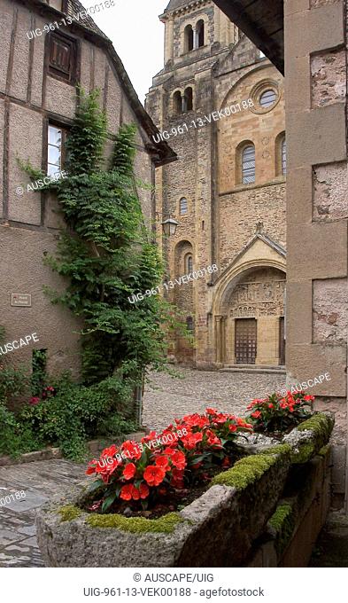 Church of Saint Foy viewed from cobblestone streets of medieval village, Conques, Auvergne region, France
