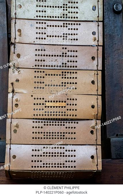 Punched cards, made of perforated paper of 19th century automated textile loom