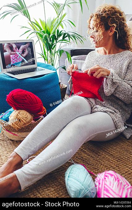 Woman, living room, sitting, knitting, laptop, video tutorial