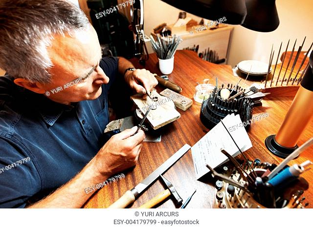 Senior man working at shaping a ring